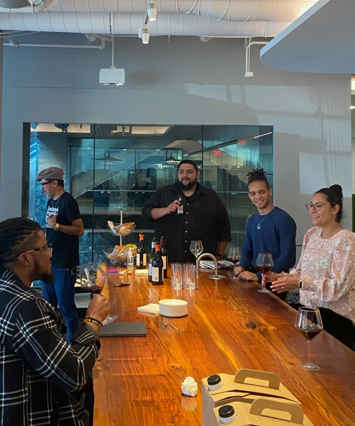 People gathered around a long wooden table at a LeaderFlow event